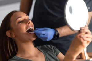 Dentist in Ann Arbor fitting a patient with Invisalign clear aligner trays