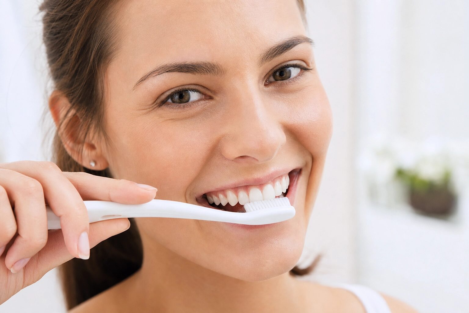 Woman brushing teeth for cavity prevention in Ann Arbor Michigan